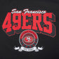 Zoomed-in image of the San Francisco 49ers team badge embroidered on the chest of the hoodie
