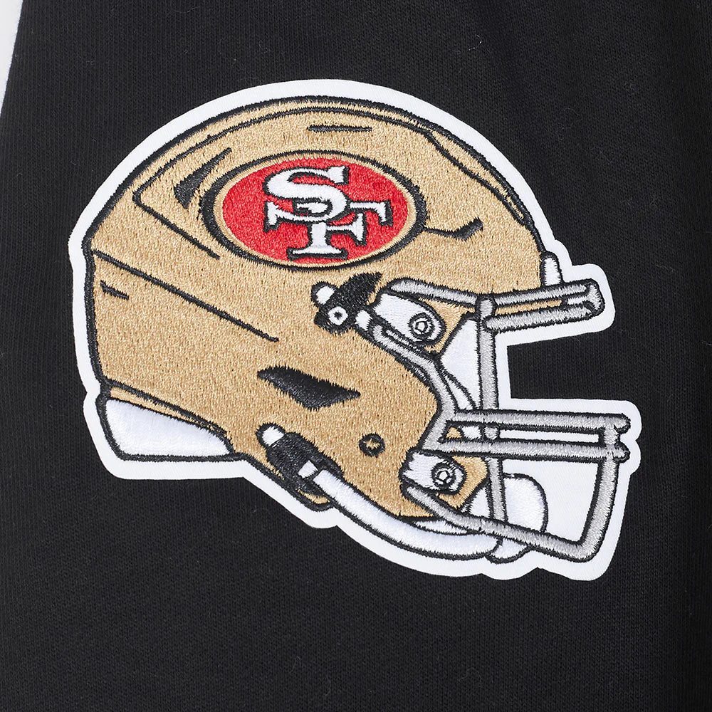 Full shot displaying the Pro Standard 49ers hoodie styled with casual jeans in a sports apparel setting