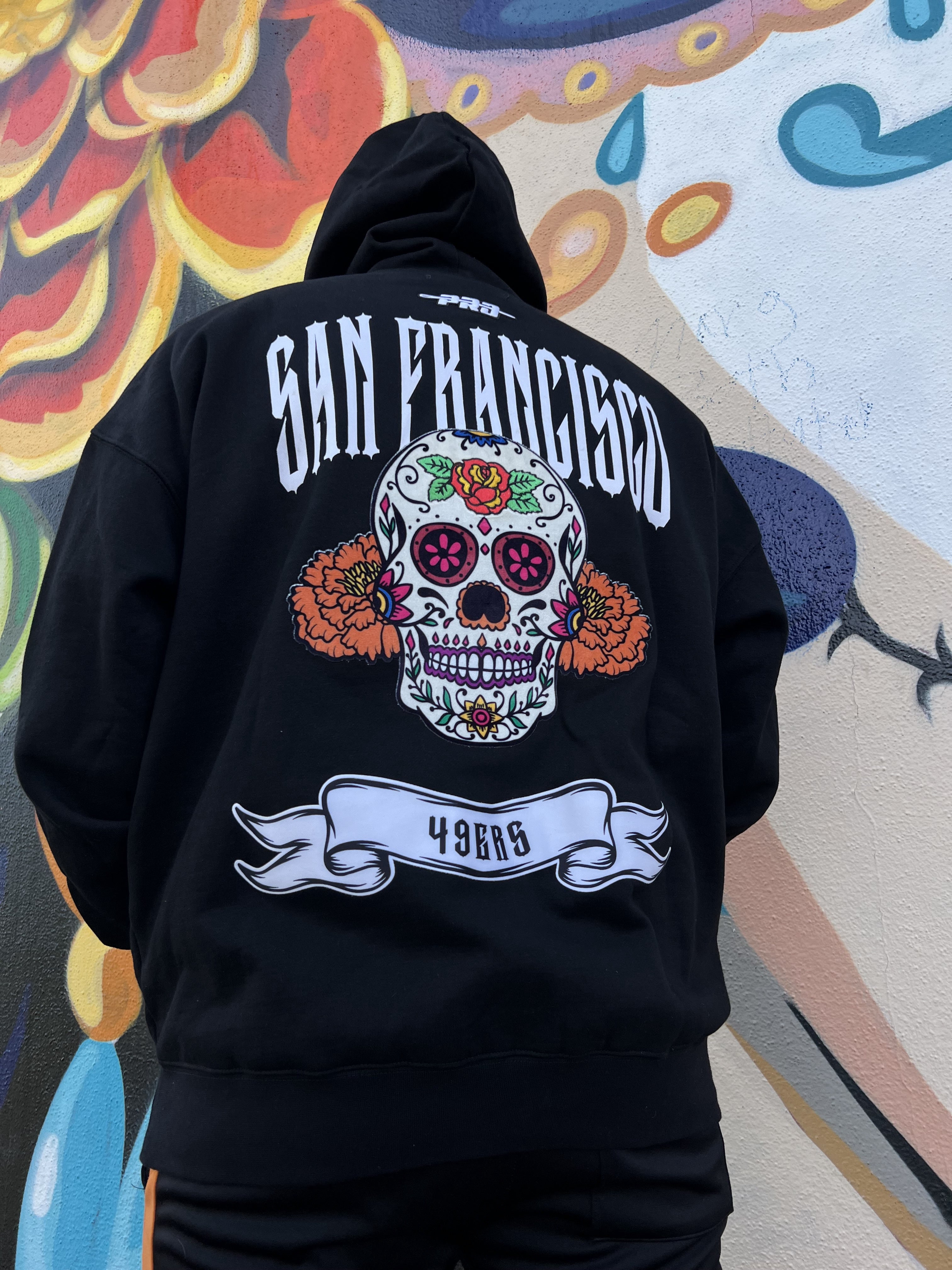 Pro Standard San Francisco 49ers Rib Cage Drop Shoulder Hoodie in Black, front view, featuring team logo and rib cage design