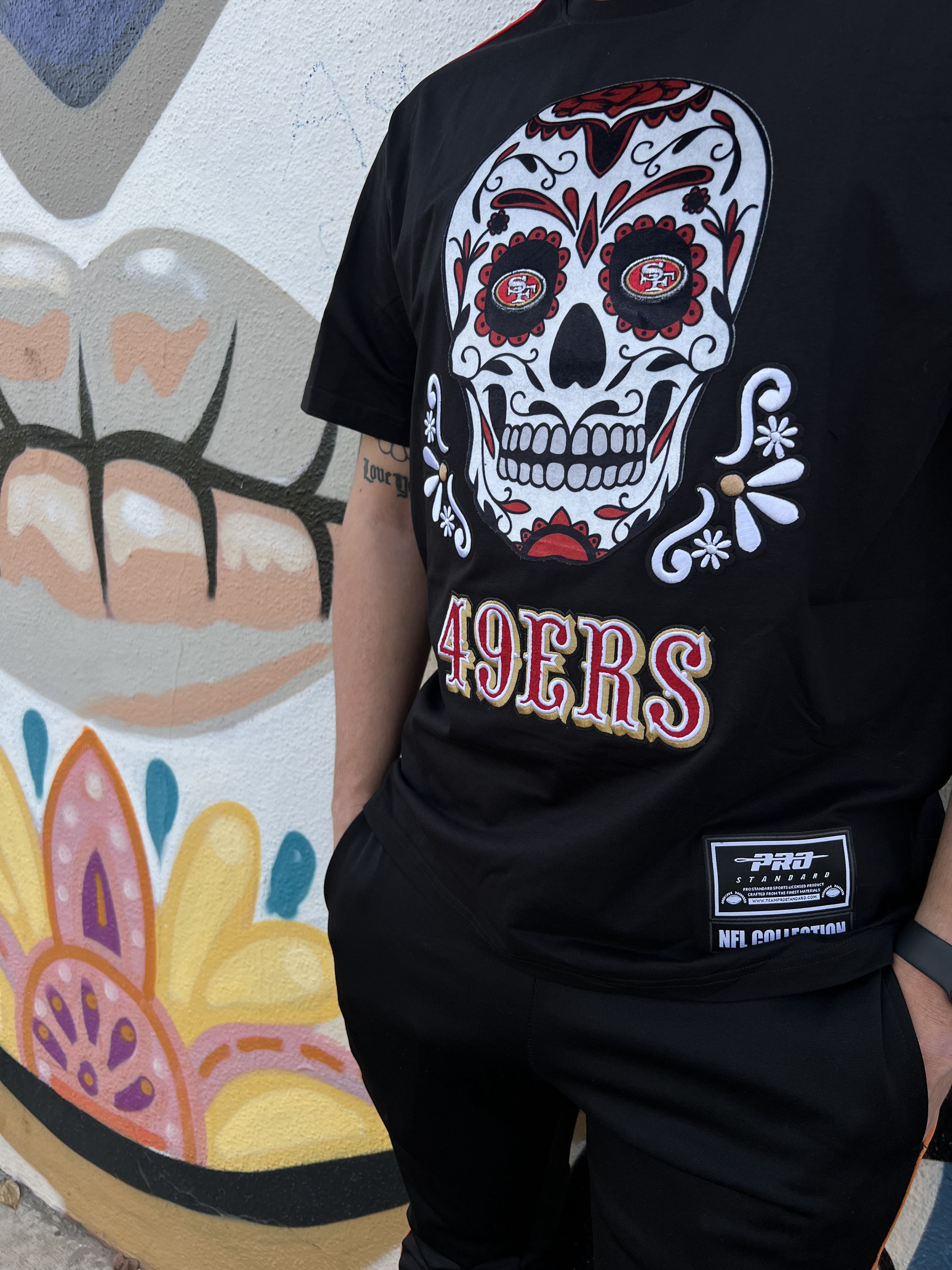 Pro Standard San Francisco 49ers Sugar Skull Striped Tee in black and red with team logo and skull design on front 