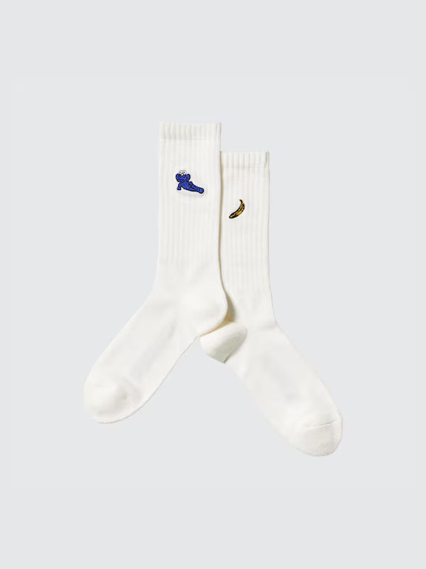 White KAWS Sesame and Warhol themed socks featuring vibrant graphic designs for artistic fashion enthusiasts