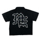 Close-up of the Me rhinestone design on the black zip-up shirt, highlighting its sparkling details and trendy style
