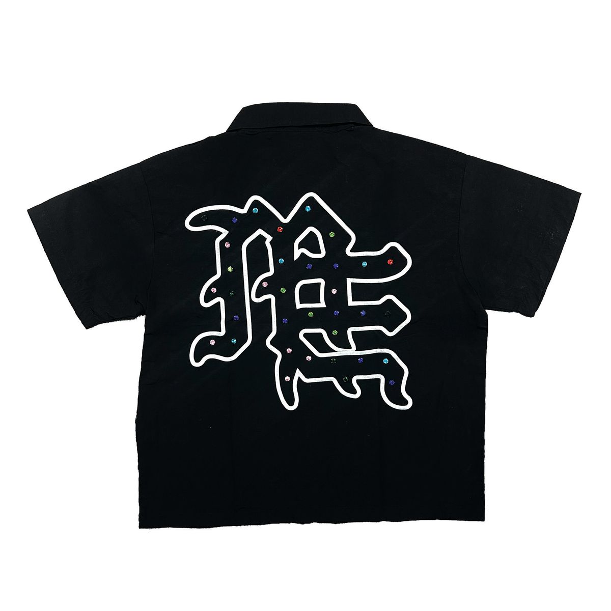 Close-up of the Me rhinestone design on the black zip-up shirt, highlighting its sparkling details and trendy style