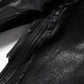 Rear view of black denim jeans highlighting patchwork design and waxed textured surface