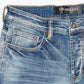Close up of Valabasas Mr Stacked Medium Washed Stacked Denim Jeans back pockets with logo embroidery