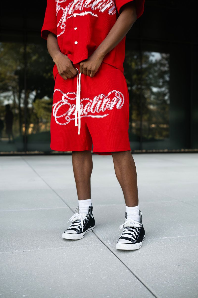 Fashionable red shorts with signature logo, perfect for everyday wear