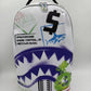 White Sprayground Shark Central Stencils Backpack showcasing 18-inch height and 115-inch width with durable PVC construction