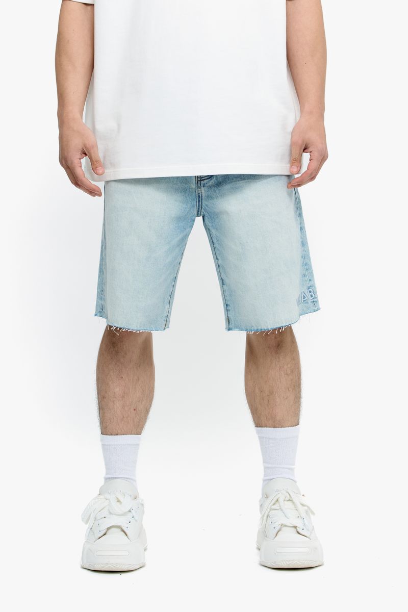 Full-length shot of Valabasas Mr Shorts in light blue wash denim laid flat on a surface