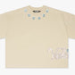 Cream-colored Valabasas Gem Tee featuring a simple yet stylish design, perfect for casual wear