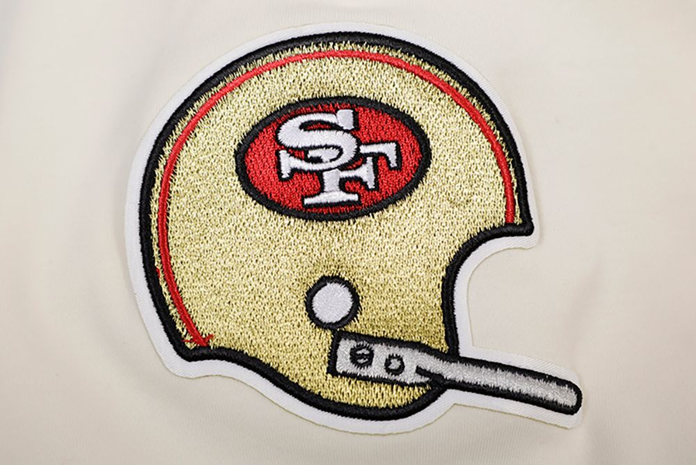 Close-up of the printed team logo and retro graphics on the eggshell and red San Francisco 49ers T-shirt