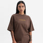 Side profile showing the relaxed fit of the PURE Knockout Script Brown Tee