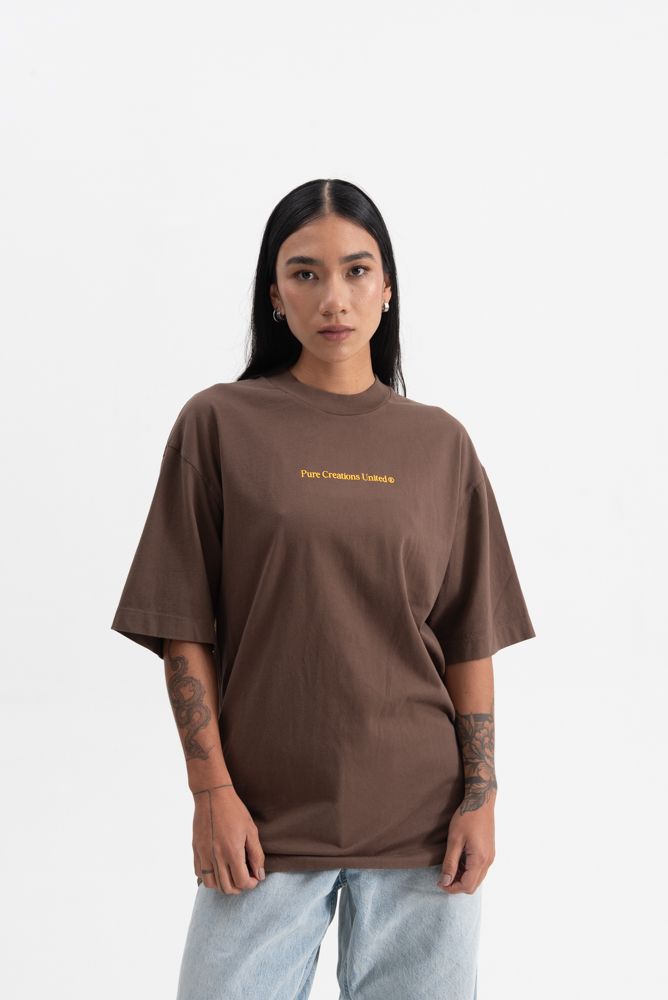 Side profile showing the relaxed fit of the PURE Knockout Script Brown Tee