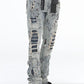Close-up of light blue paint splatter pattern on Stacked Flare Ripped Jeans