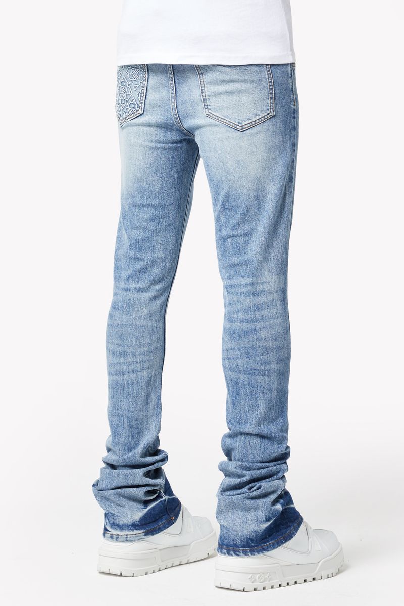 A person wearing the Guapi Pacific Blue Basics Stacked Denim walking outdoors
