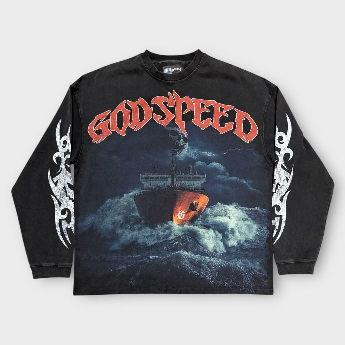 Premium black wash long sleeve T-shirt featuring a bold Rough seas make good sailors graphic with a unique stone-accented crown design