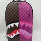Close-up of the pink check pattern on the Sprayground Split Sip backpack showcasing durable PVC material