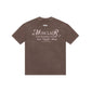 Flat lay of PURE Monclair Brown Tee showing its rich brown color and high-quality cotton material