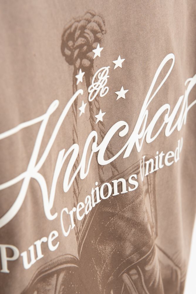 Artistic shot emphasizing the natural brown color and relaxed fit of the PURE Knockout Gloves Tee