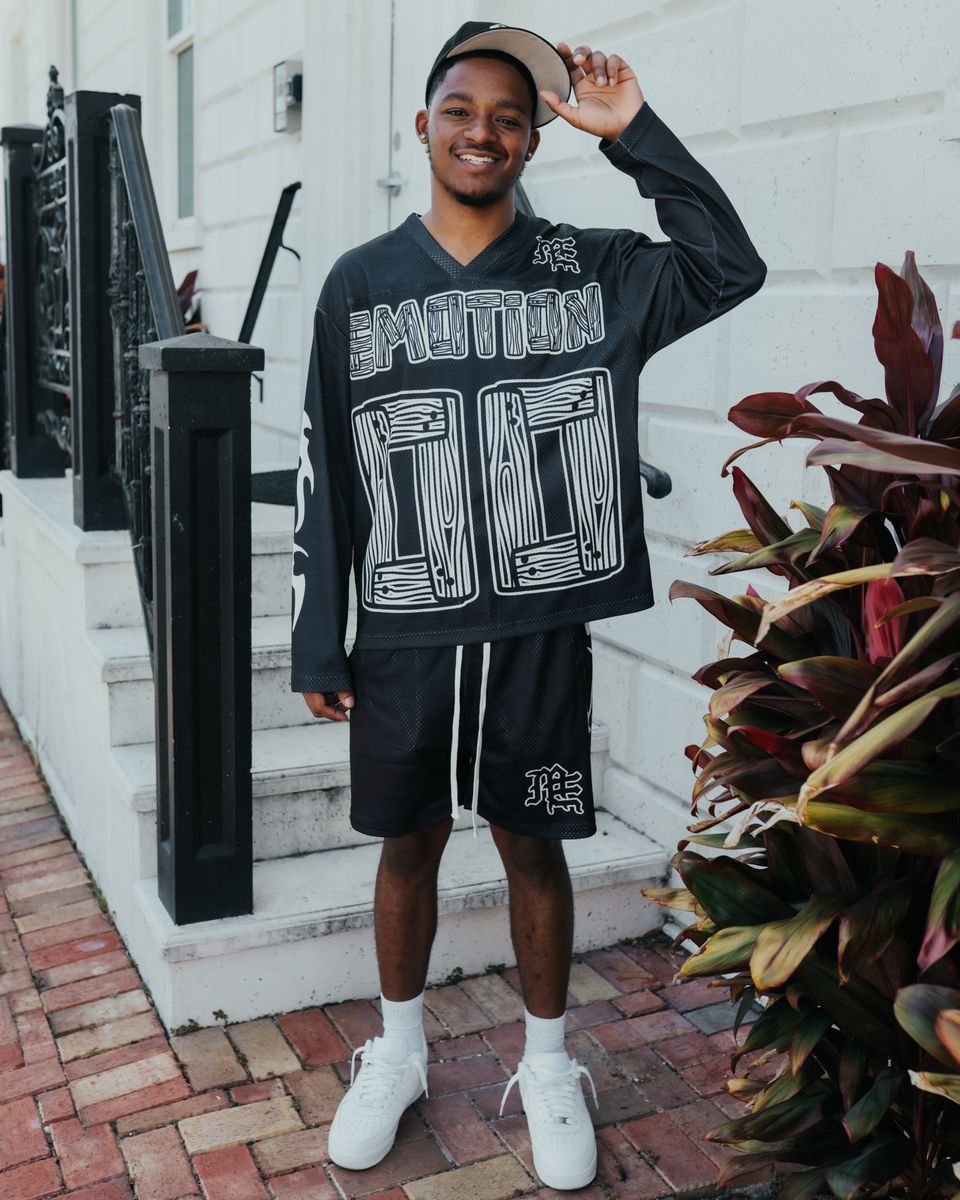 Long sleeve black shirt with a prominent lightning graphic, offering a trendy oversized silhouette