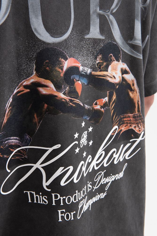 Side angle highlighting the oversized fit and comfortable design of the PURE Knockout Fight Black Tee