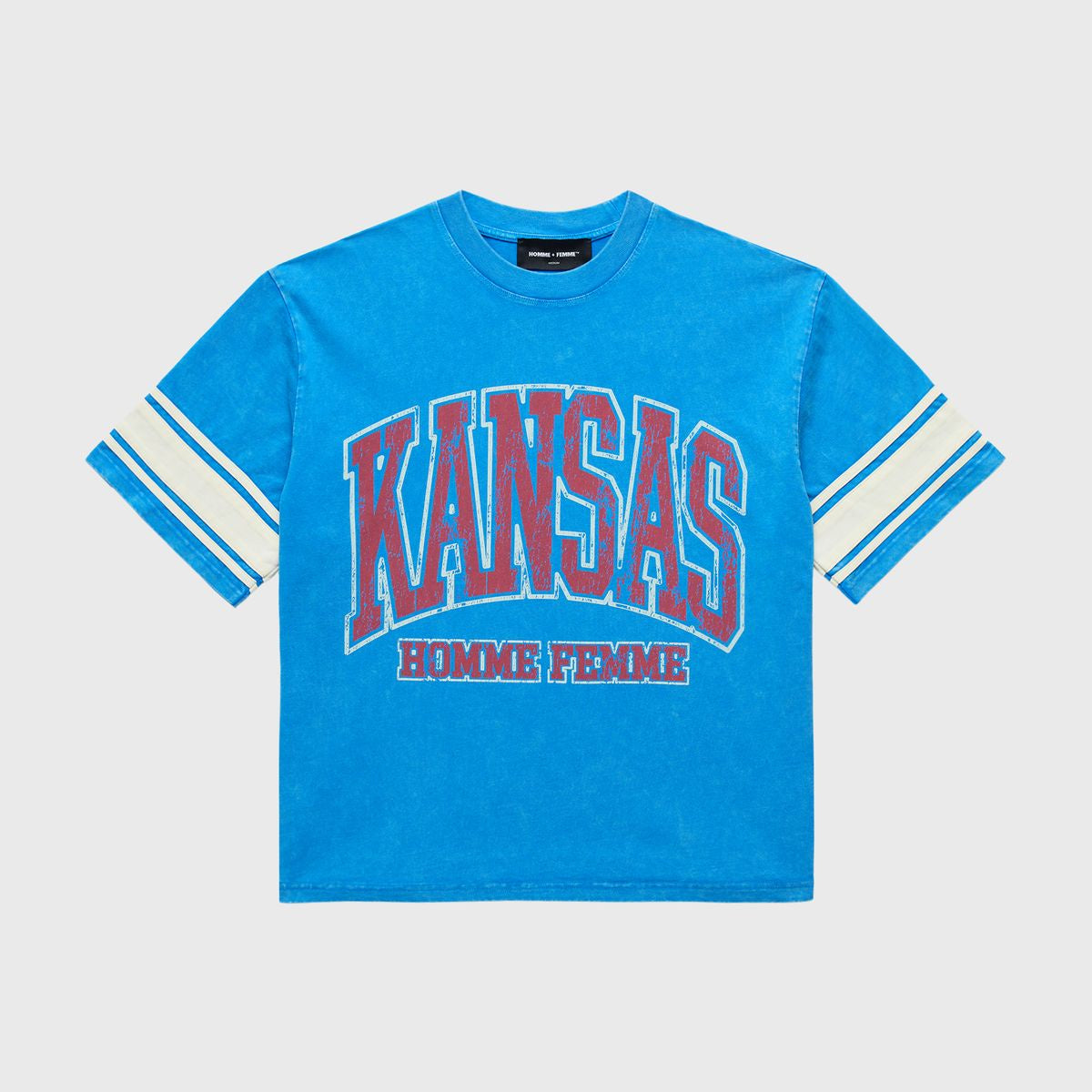 A cropped blue T-shirt featuring varsity stripe sleeves, bold KANSAS print on the chest, Homme Femme logo below, stone washed vintage look, heavyweight cotton, perfect for Spring 2025 collection