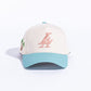 Side view of Paradise LA Snapback Hat in cream, teal, and pink color combination with flat brim and stitched eyelets