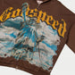 Close-up of the chrome Statue of Liberty reflecting blue skies on the brown wash zip hoodie