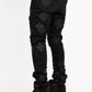  Side view of Guapi All Black Icon Stacked Denim Jeans showing the stacked fit and black wash