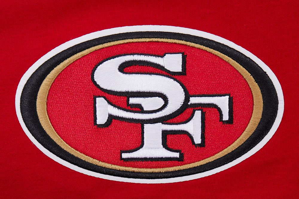 Side angle showing the design details of the San Francisco 49ers script tail shorts in red and black