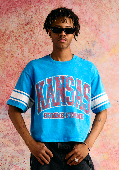 Cropped blue tee with varsity stripe sleeves and bold KANSAS print on front