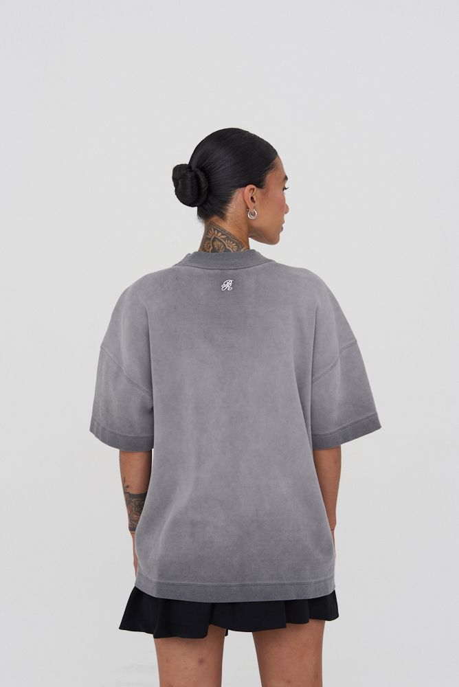 Back view of the oversized T-shirt displaying its relaxed silhouette and high-quality washed grey cotton fabric
