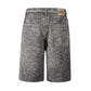 Close-up of baggy Noir Rhinestone Denim Shorts showcasing light stone wash, heavyweight denim, and intricate rhinestone embellishments with a removable belt