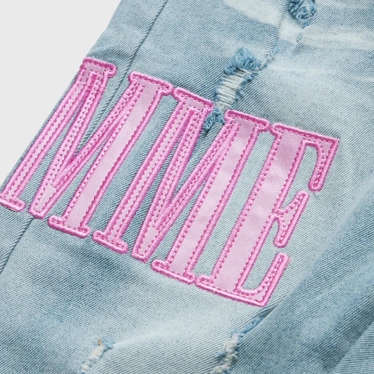 
Close-up image of Homme + Femme Letterman Blue Denim w/Powder Pink jacket showcasing the high-quality denim material in a rich blue tone and the soft powder pink sleeves with ribbed cuffs, highlighting the attention to detail and stylish design of this versatile unisex jacket