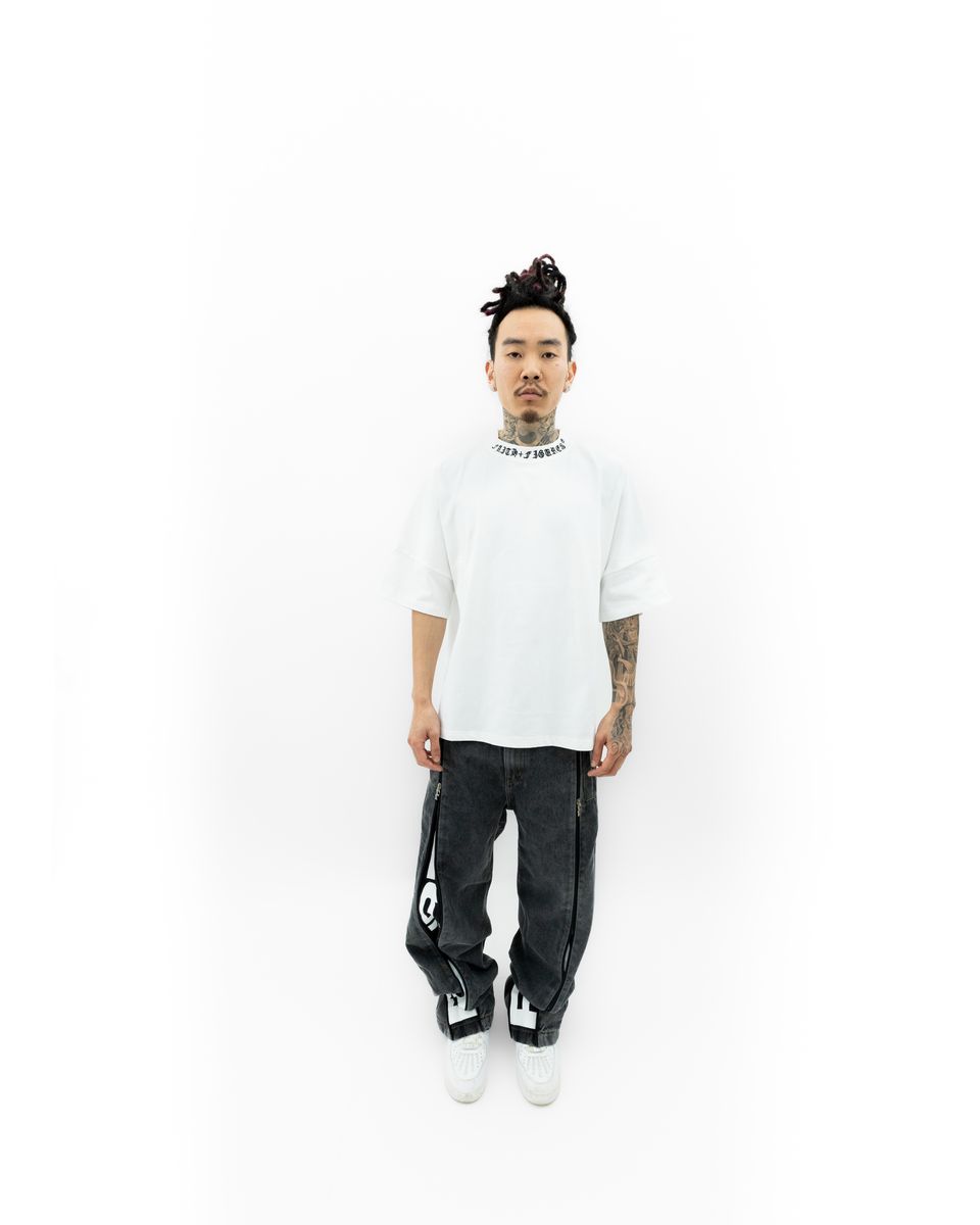 Side profile of the Faith+Figures Faith+ Jumbo SS Tee emphasizing its clean stitching and casual everyday wear appeal