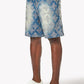 Close-up of embellished geometric design on vintage blue denim shorts showing detailed craftsmanship