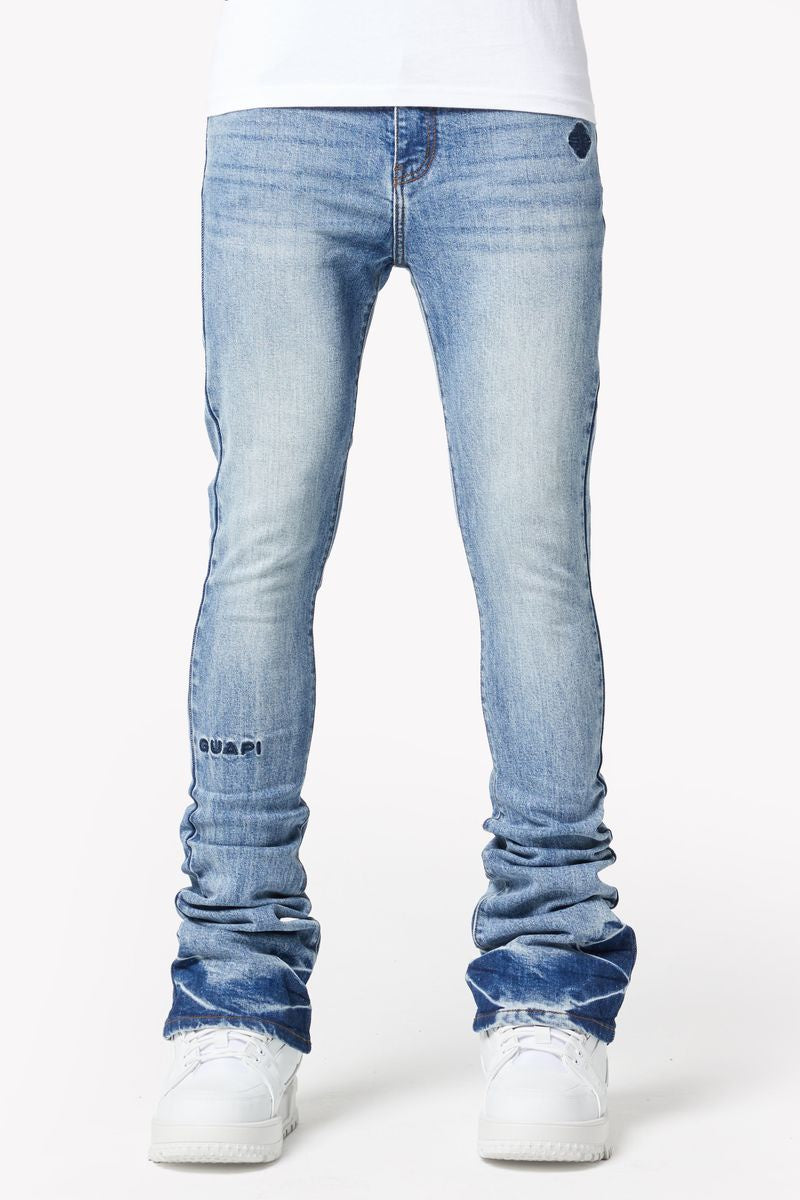 Guapi Pacific Blue Basics Stacked Denim jeans laying flat on a wooden surface