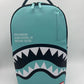 Close-up of the Sprayground Shark Central Aqua DLXSV Backpack highlighting 100% PVC material and sturdy zippers