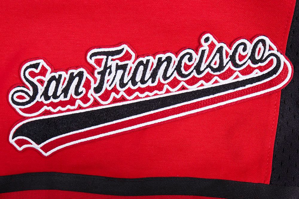 Back view of athletic shorts displaying team logo and script tail design in red and black