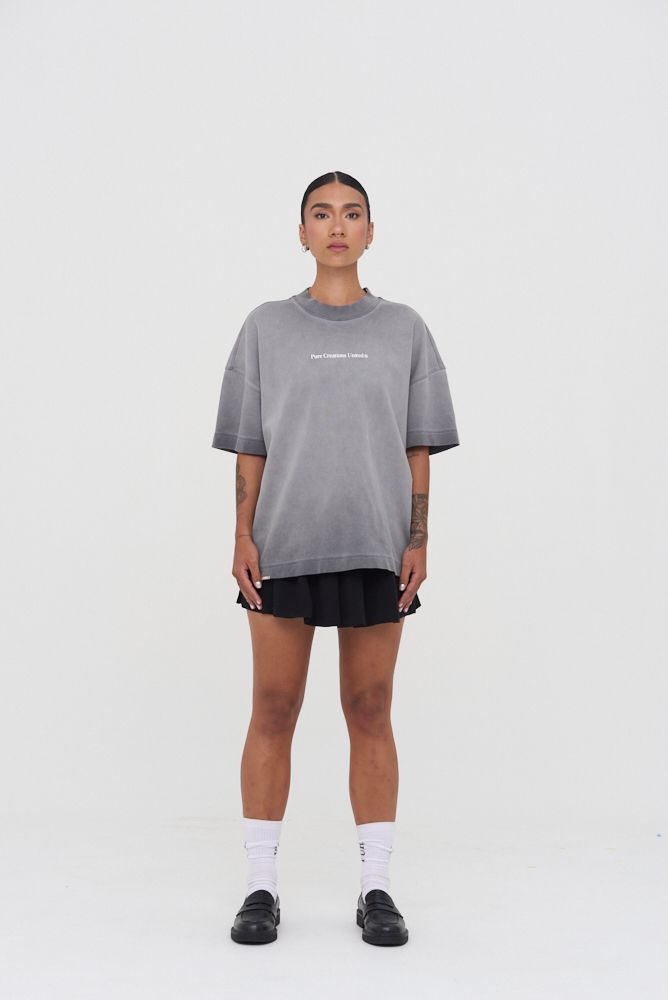  Full-length display of the oversized grey wash T-shirt worn casually, demonstrating its relaxed fit and versatile style