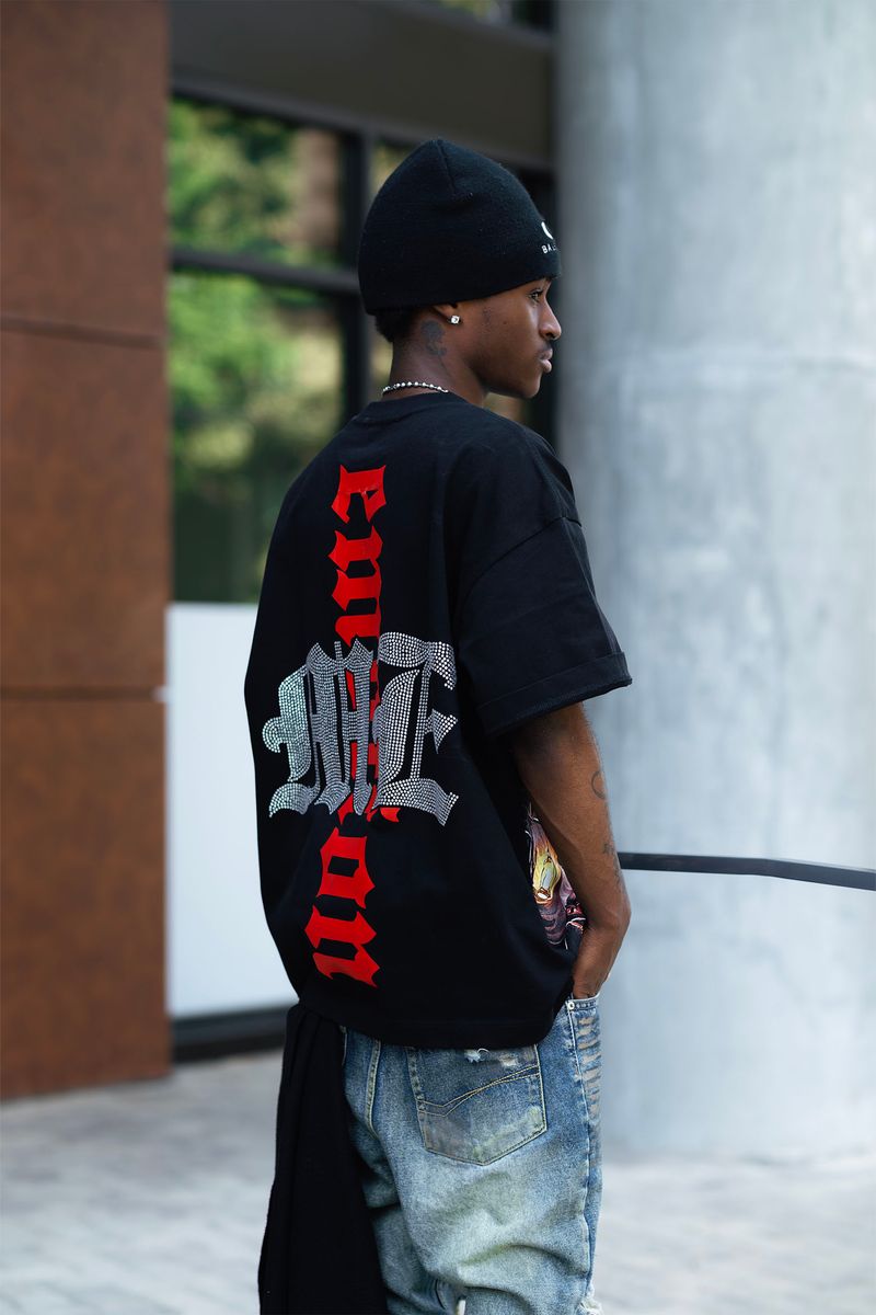 Detail shot of the rhinestone embellishments forming the octopus pattern on the black tee