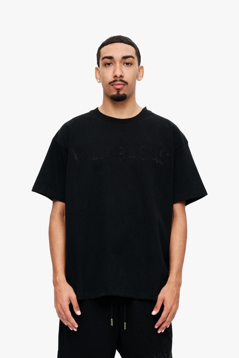 A close-up image of the Valabasas Temptation Black Tee showcasing its sleek black fabric and minimalist design