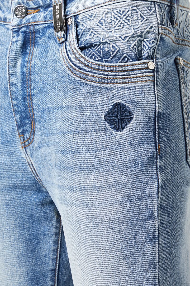 Guapi Pacific Blue Basics Stacked Denim hanging on a clothing rack in a retail store