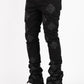 Front view of Guapi All Black Icon Stacked Denim Jeans with distressed details and logo patch