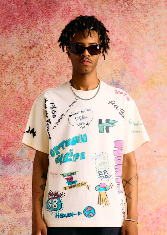 Casual off white Rest Stop T-shirt with authentic bathroom graffiti doodles, perfect for a relaxed, stylish look