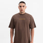 Front view of the PURE Knockout Script Brown Tee highlighting the oversized fit