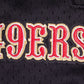 Full-length shot of the red and black San Francisco 49ers athletic shorts with script tail branding
