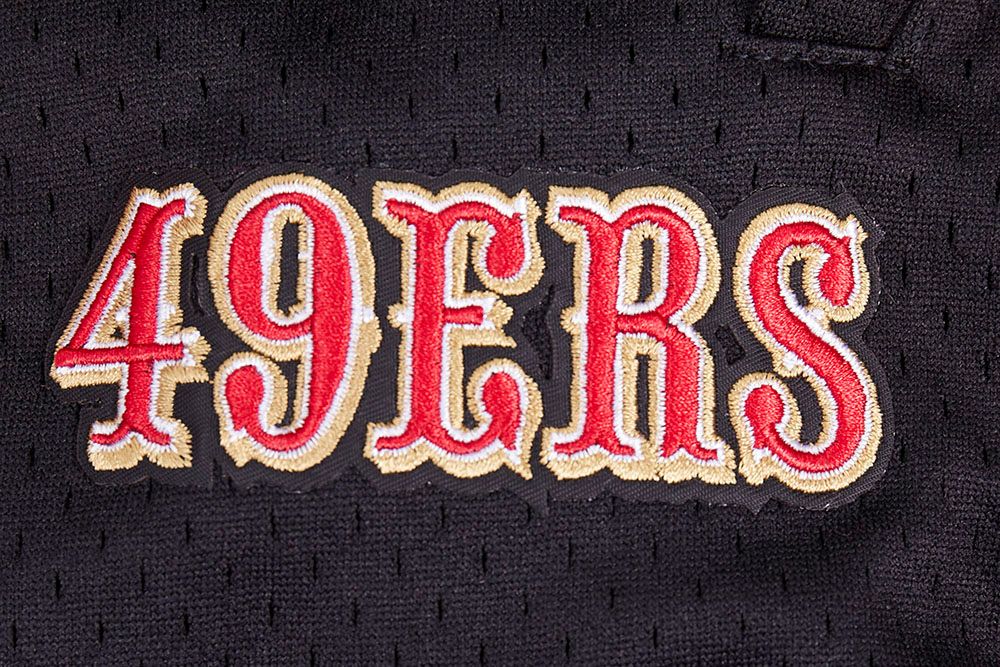 Full-length shot of the red and black San Francisco 49ers athletic shorts with script tail branding