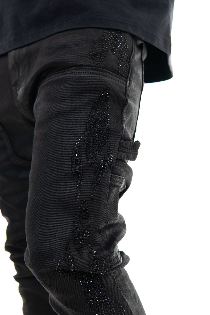 Close-up of Vicious Embellished Wax Coated Black Denim Jeans showcasing detailed embellishments and wax coating for a stylish look