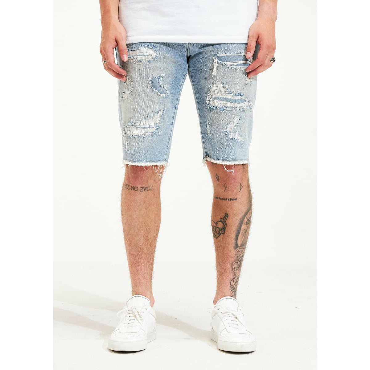 Embellish light blue sunset ripped shorts with distressed detailing and frayed hem