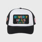 Classic Beverly Hills trucker hat in black and white featuring a front patch, colorful diamond detail, and logos on side panels